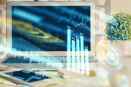 Computer on desktop in office with technology theme hologram. Double exposure. Tech concept.の写真素材