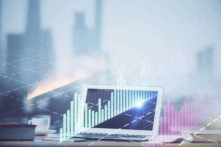 Forex graph hologram on table with computer background. Multi exposure. Concept of financial markets.の写真素材