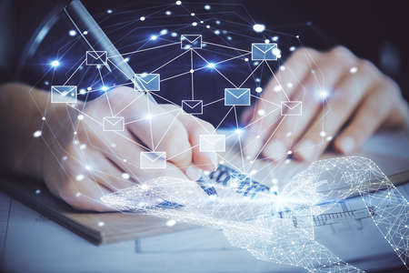 E-mail abstract envelop drawing over hands taking notes background. Concept of electronic mail....
