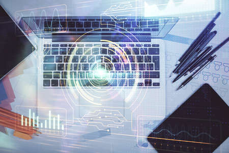 Multi exposure of data drawing hologram over topview of study desk background with computer. Concept...