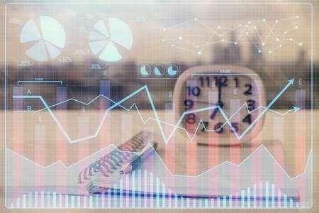 Double exposure of financial graph drawings and desk with open notebook background. Concept of forex...