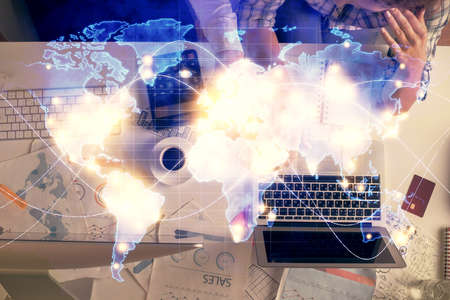 Double exposure of man and woman working together and business theme hologram drawing. Computer...