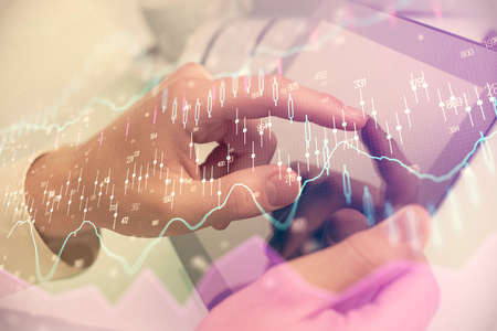Multi exposure of man's hands holding and using a phone and financial chart drawing. Market analysis...