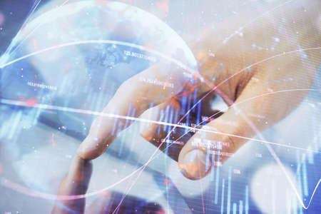 Multi exposure of man's hands holding and using a phone and financial chart drawing. Market analysis...