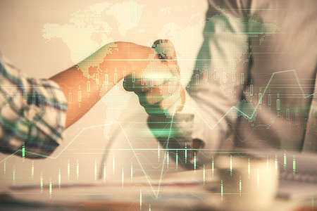 Double exposure of forex graph hologram and handshake of two men. Stock market concept.