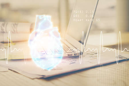 Desktop computer background and heart drawing. Double exposure. Medical study and healthcare concept.の写真素材