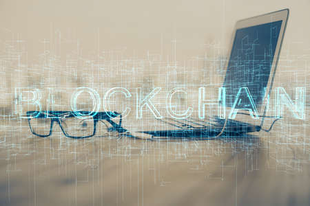 Multi exposure of blockchain theme hologram and table with computer background. Concept of bitcoin...