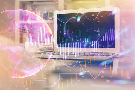 Financial graph colorful drawing and table with computer on background. Double exposure. Concept of...