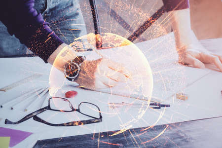 Man's hands working with notes background. Social networking concept. Crowd sourcing. Global business. Multi exposure.の写真素材