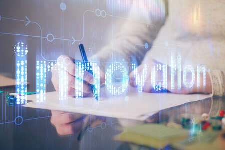 Double exposure of writing hand on background with data technology hologram. Big data concept.