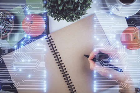 Tech theme hologram over woman's hands taking notes background. Concept of hightech. Double exposure