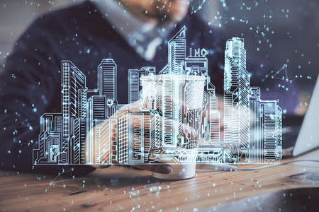 High tech city drawing with businessman working on computer on background. Smartcity concept. Double exposure.の写真素材