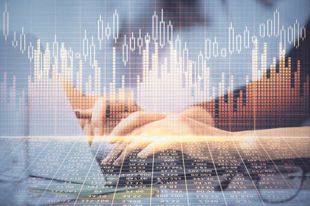 Multi exposure of woman hands typing on computer and financial graph hologram drawing. Stock market...