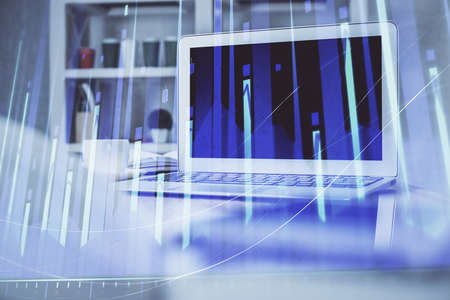 Stock market graph and table with computer background. Multi exposure. Concept of financial...