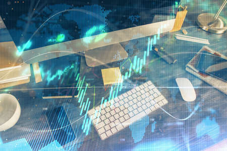 Multi exposure of chart and financial info and work space with computer background. Concept of...