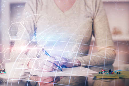 Multi exposure of hands making notes with world map hologram and data theme icons. Concept of global computer data.の写真素材