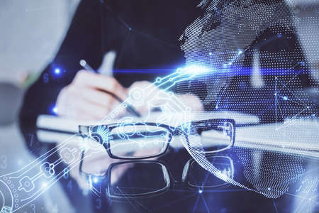 Tech theme hologram over woman's hands taking notes background. Concept of hightech. Double exposure