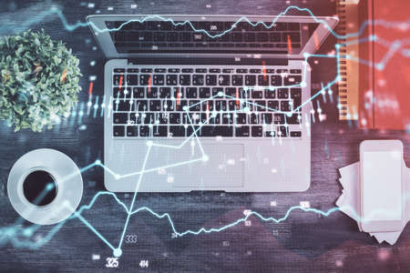 Stock market chart and top view computer on the table background. Double exposure. Concept of financial analysis.の写真素材