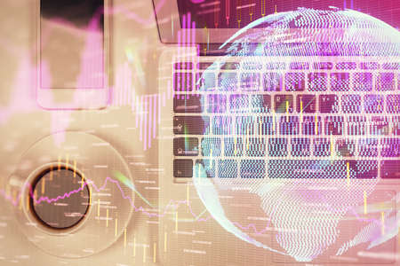 Stock market chart and top view computer on the table background. Multi exposure. Concept of...