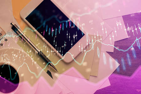 Multi exposure of forex graph hologram over desktop with phone. Top view. Mobile trade platform...