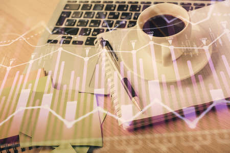 Double exposure of forex chart drawing and desktop with coffee and items on table background. Concept of financial market tradingの写真素材