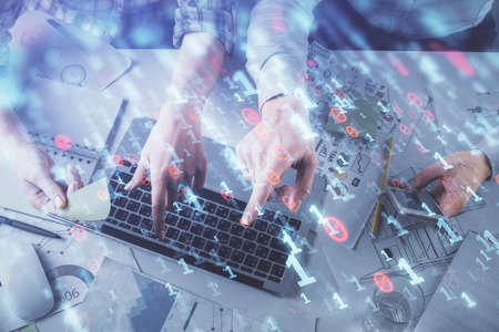 Double exposure of man and woman working together and data theme hologram drawing. Computer...