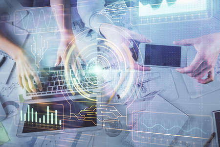 Double exposure of man and woman working together and data theme hologram drawing. Computer...