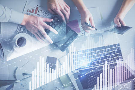Double exposure of man and woman working together and financial chart hologram drawing. market...