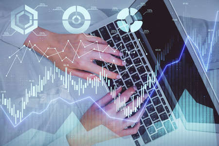 Double exposure of woman hands working on computer and forex chart hologram drawing. Top View....