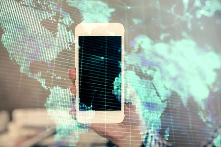Double exposure of man's hands holding and using a phone and international business theme drawing.の写真素材