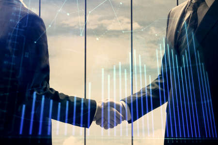 Double exposure of forex graph hologram and handshake of two men. Stock market concept.