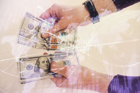 Multi exposure of financial graph drawing hologram and USA dollars bills and man hands. Analysis...