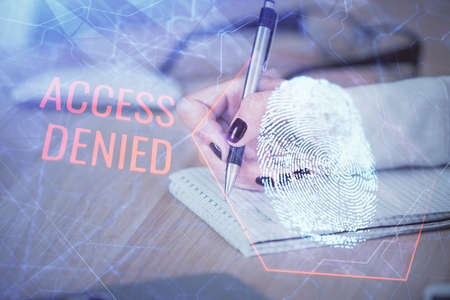 Blue fingerprint hologram over woman's hands taking notes background. Concept of protection. Double...