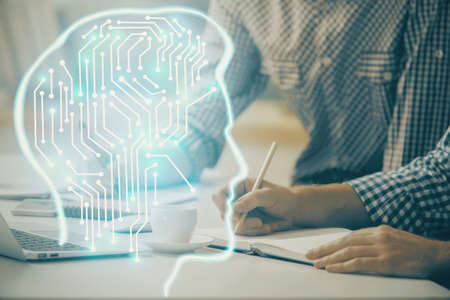 Man typing on keyboard background with brain hologram. Concept of big Data.