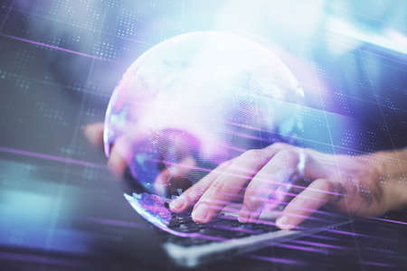 Technology theme hologram with man working on computer on background. High tech concept. Multi...