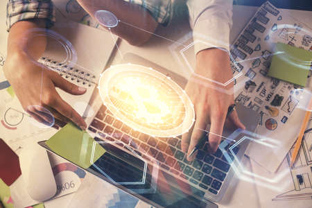 Double exposure of man and woman working together and crypto theme hologram drawing. Computer...