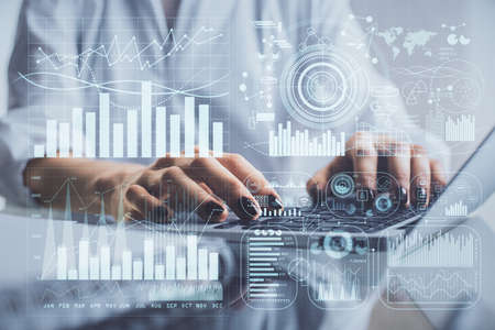 Double exposure of woman hands typing on computer and forex chart hologram drawing. Stock market...