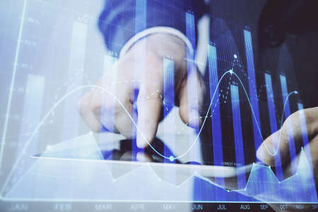Multi exposure of man's hands holding and using a phone and financial chart drawing. Market analysis concept.の写真素材