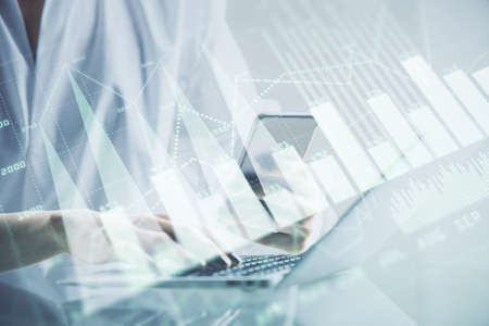 Double exposure of financial graph sketch hologram and woman holding and using a mobile device....