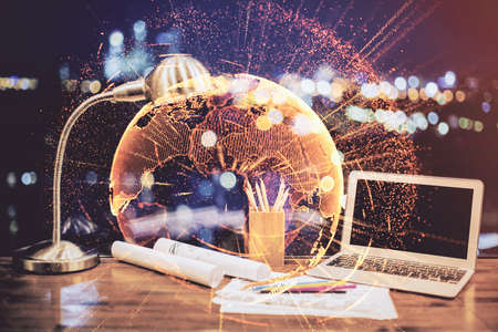 Computer on desktop with social network hologram. Double exposure. Concept of international people connections.の写真素材
