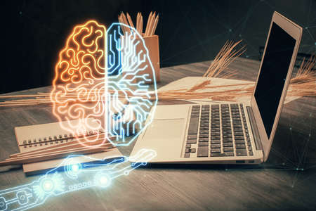 Double exposure of desktop with computer and brain drawing hologram. Artificial intelligence concept.の写真素材