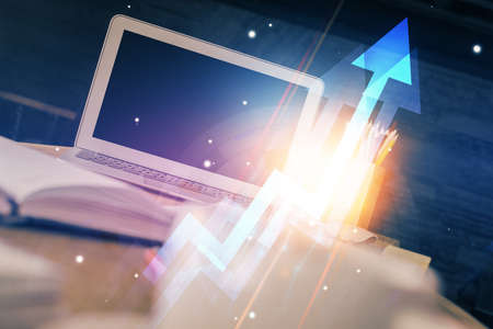 Computer on desktop with point up arrows hologram. Double exposure. Concept of success.の写真素材
