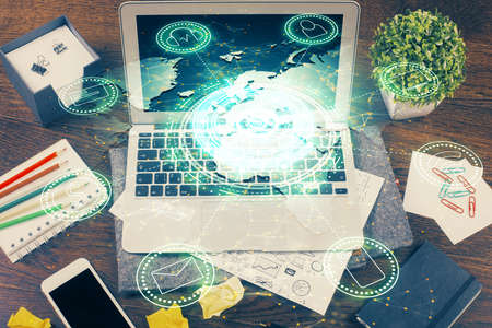 Computer on desktop with social network hologram. Multi exposure. Concept of international people...