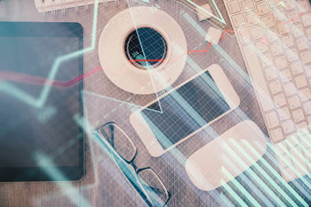 Multi exposure of forex graph hologram over desktop with phone. Top view. Mobile trade platform concept.の写真素材