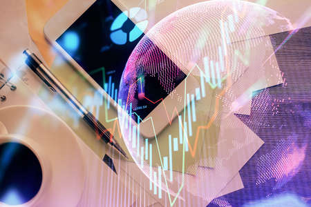 Multi exposure of forex graph hologram over desktop with phone. Top view. Mobile trade platform...