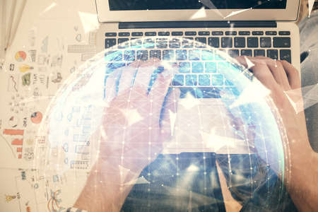 Double exposure of man's hands typing over computer keyboard and business theme hologram drawing. Top view. Financial markets concept.の写真素材
