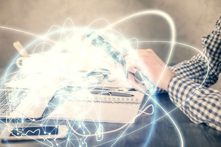 Double exposure of man's hands holding and using a phone and international business theme drawing.