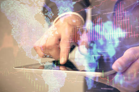 Multi exposure of man's hands holding and using a phone and financial chart drawing. Market analysis...