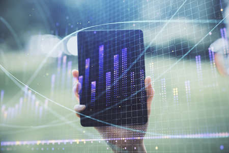 Double exposure of forex chart sketch hologram and woman holding and using a mobile device....