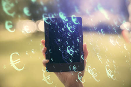 Double exposure of forex chart sketch hologram and woman holding and using a mobile device....